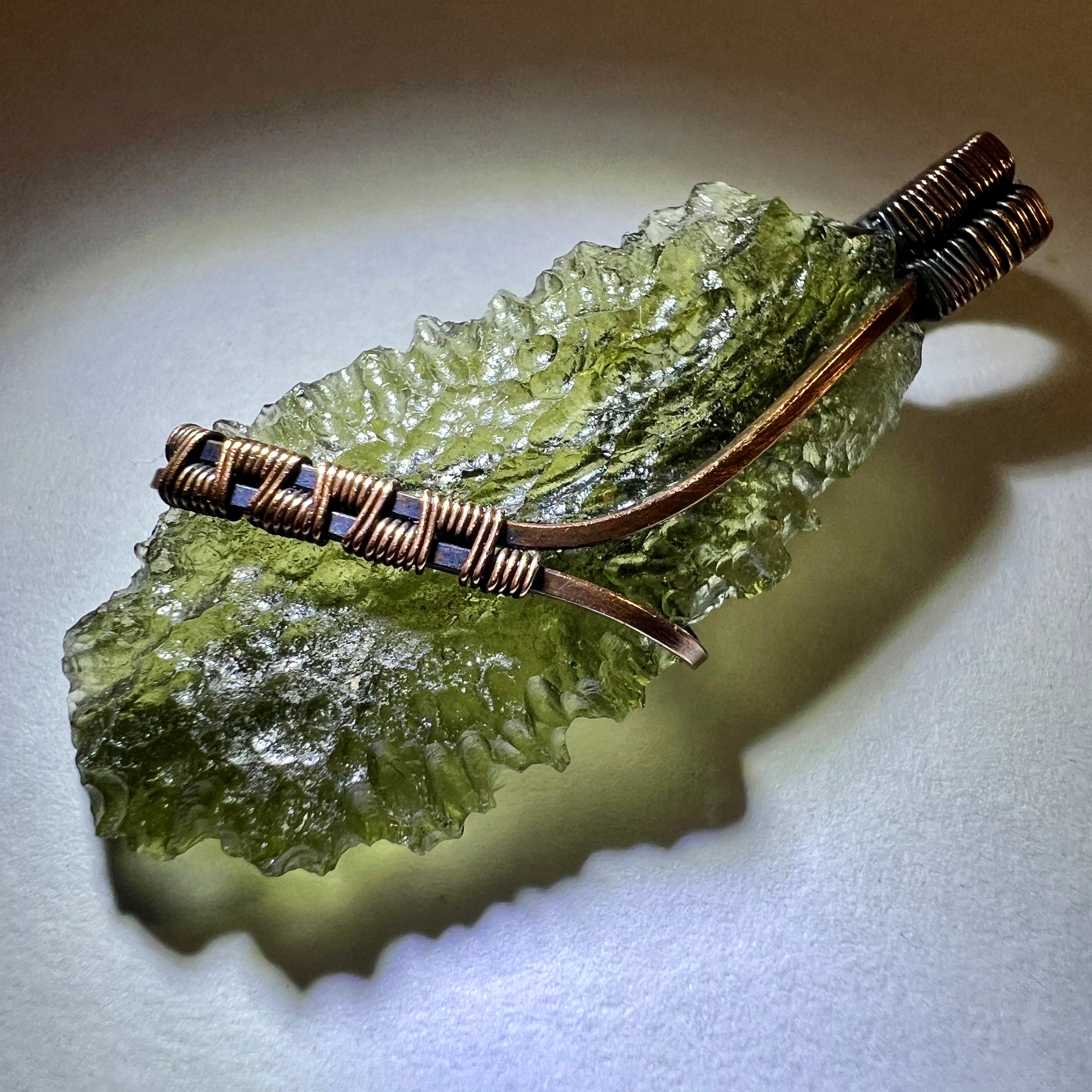 Moldavite pendant, elegant copper setting.