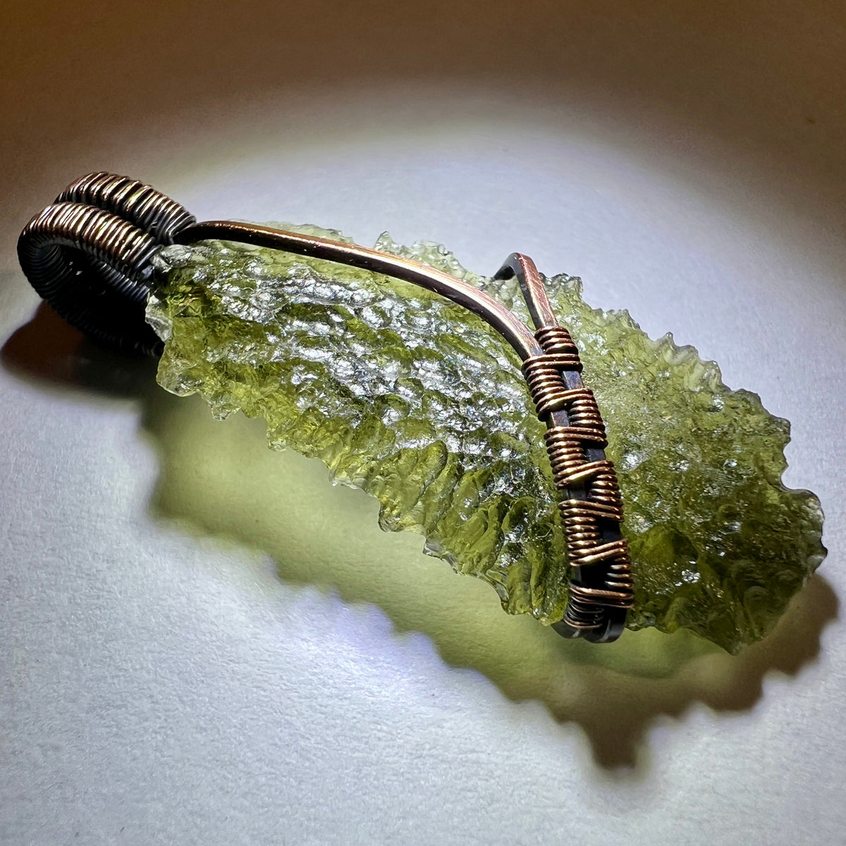 Moldavite pendant, elegant copper setting.