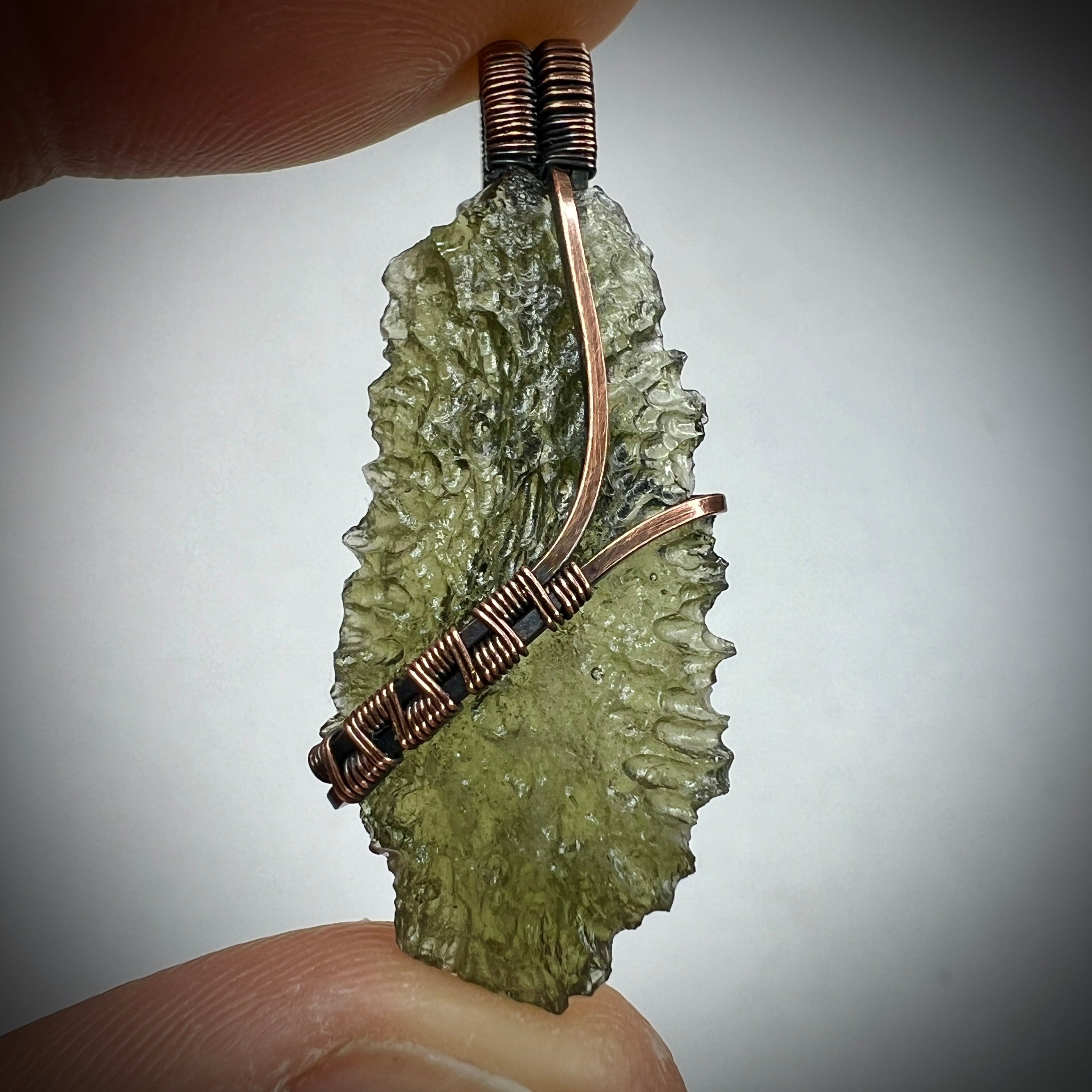 Moldavite pendant, elegant copper setting.
